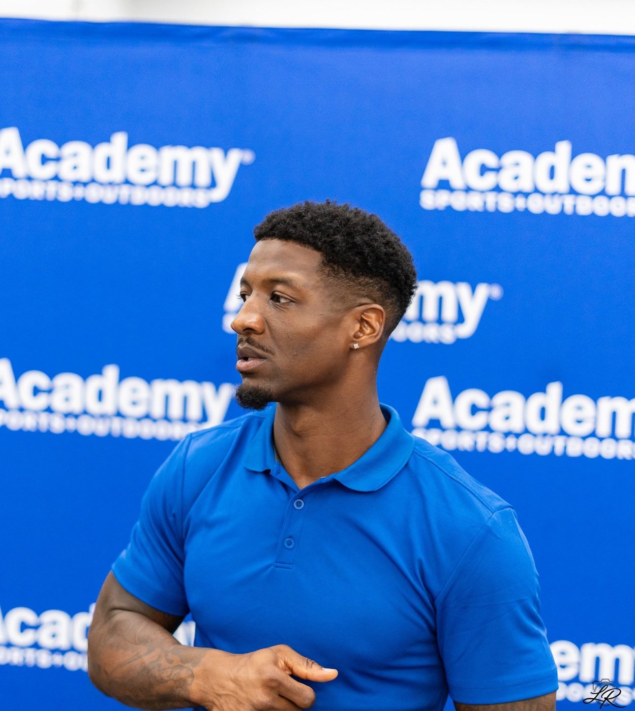 Anthony Miller II in an Academy Sports polo at the giveaway event