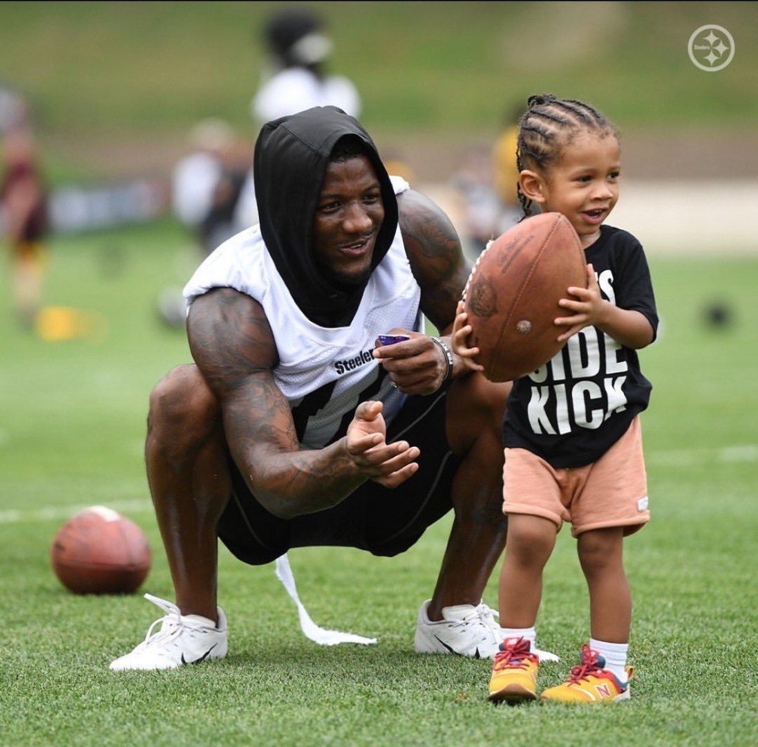 Anthony Miller II mentoring a young camper on the field