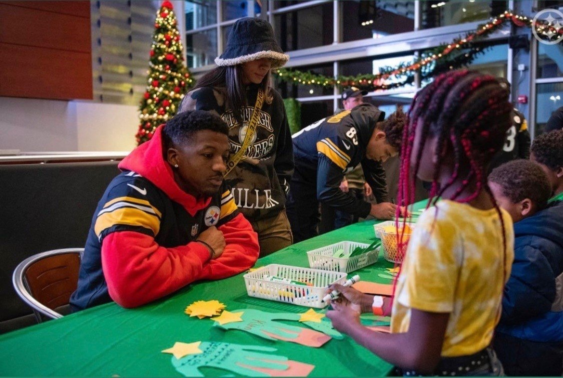Anthony Miller II with children at a Boys and Girls Club
