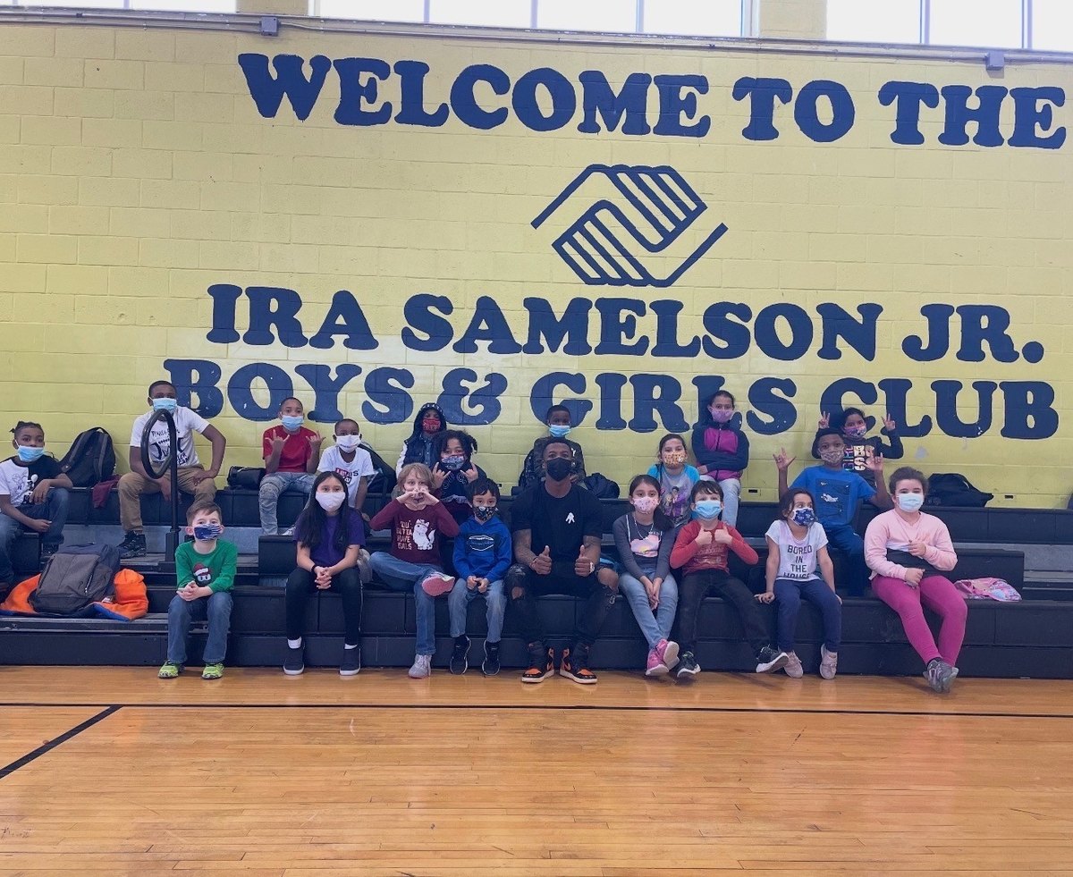 Anthony Miller II with young children at a community visit
