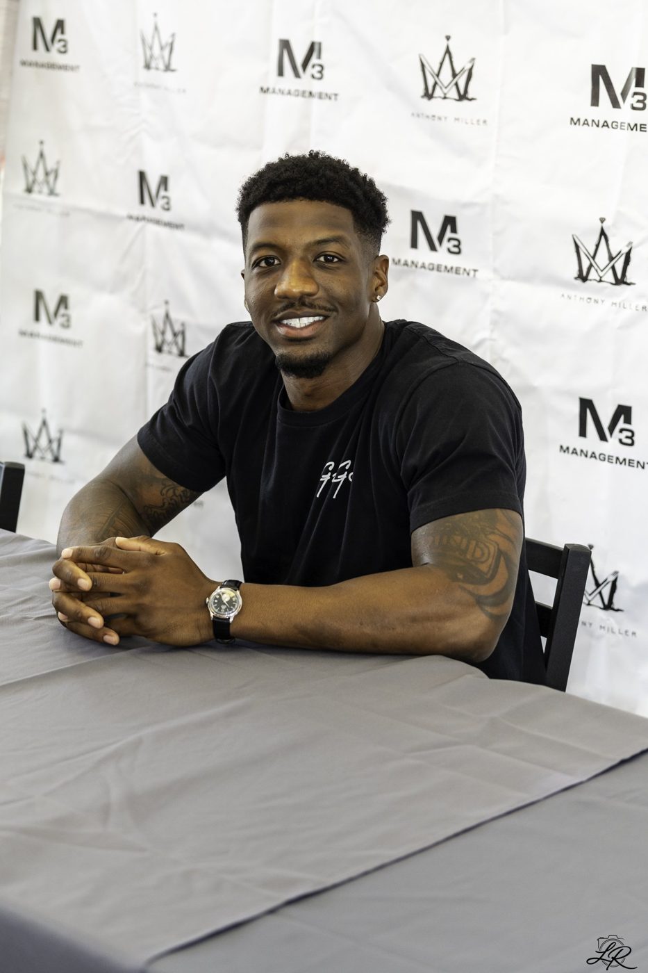 Anthony Miller laughing with fans at the signing table