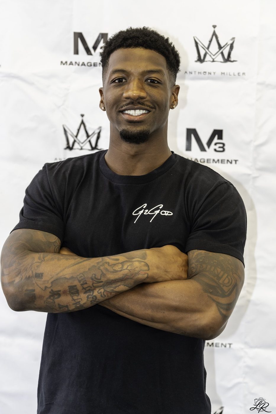 Anthony Miller posing with arms crossed at the signing backdrop