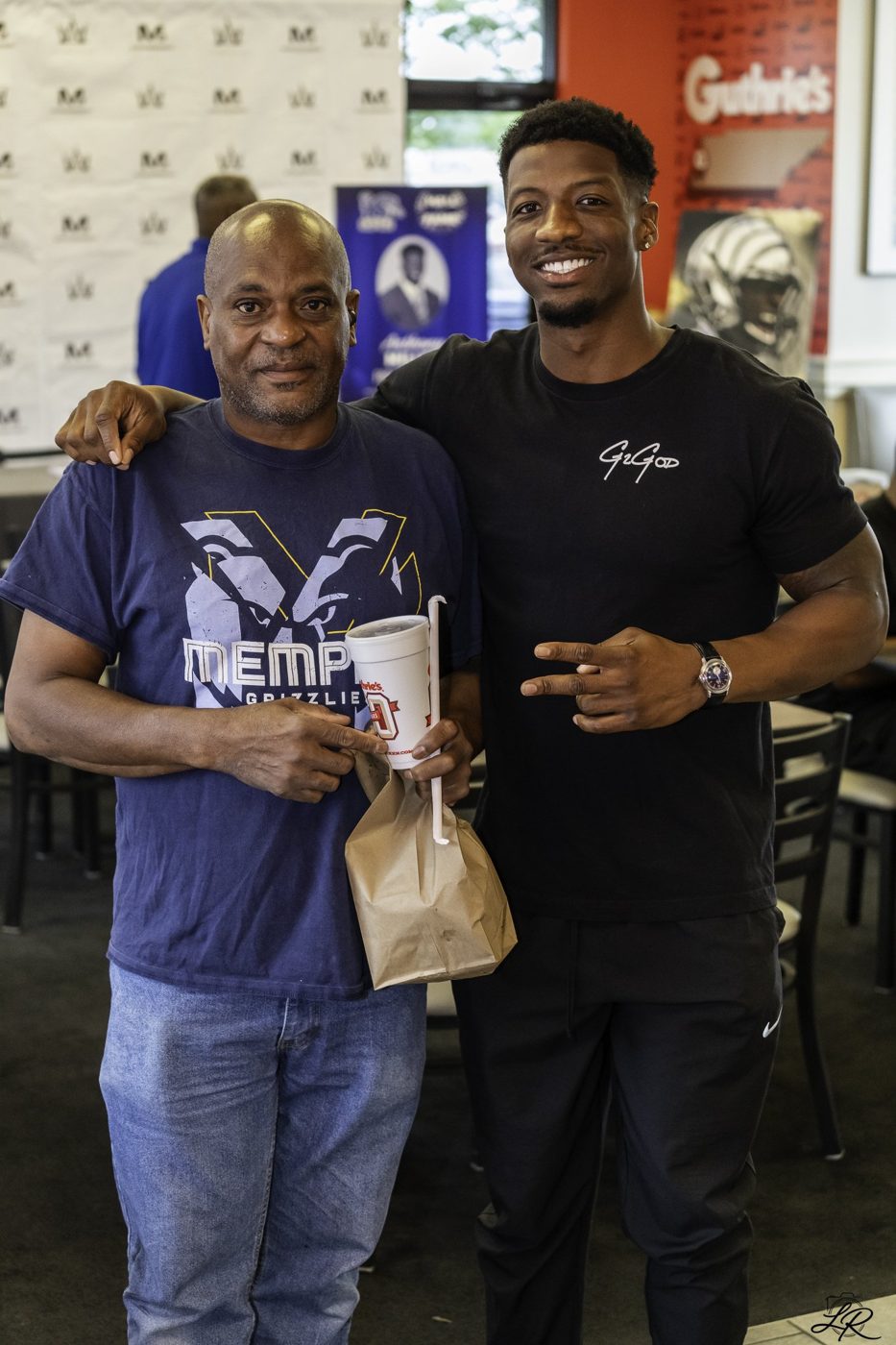 A fan posing with Anthony Miller and Guthrie's gift bags