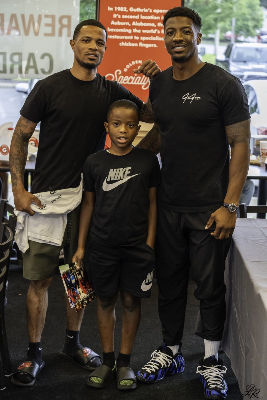 A group of young athletes posing with Anthony Miller