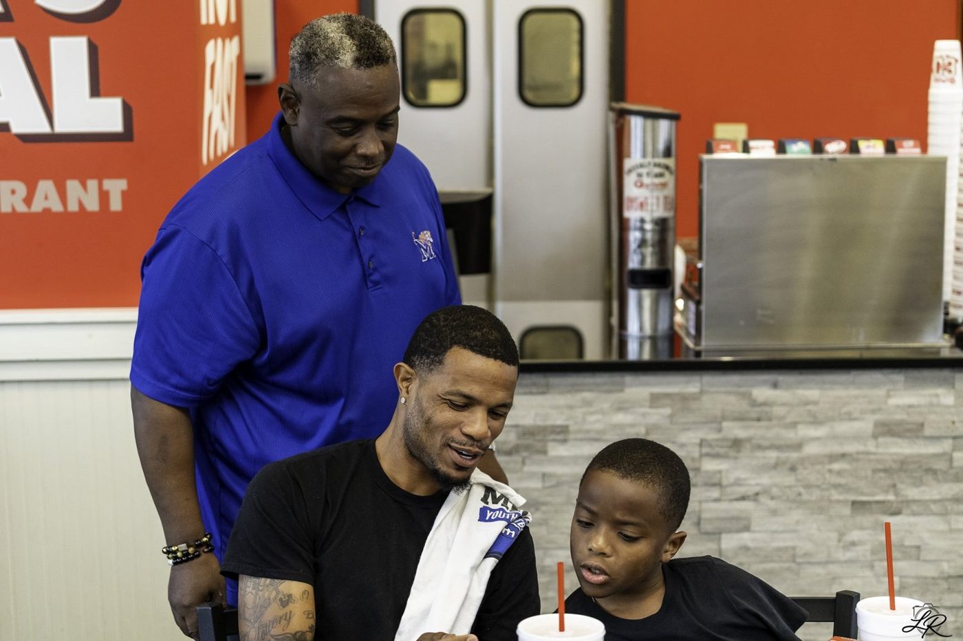 Anthony Miller leaning in to greet young fans at the signing table